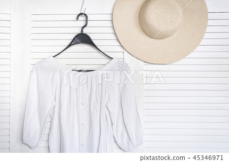 White blouse hanging on a hanger 45346971