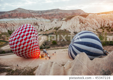 Hot air balloon flying over rock landscape at Turkey. Cappadocia 45347228