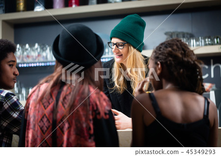 Group of friends enjoying a drink in the bar 45349293