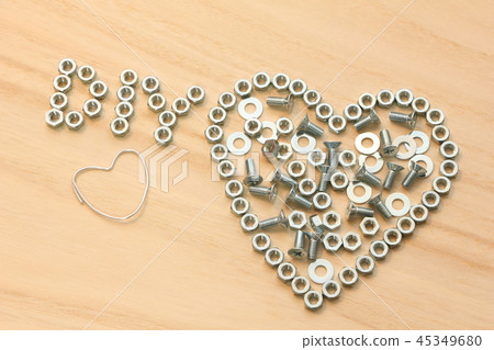 Heart symbol and "DIY" characters drawn on a wooden board with hardware. Heart symbol and "DIY" characters drawn on a wooden board with hardware. 45349680