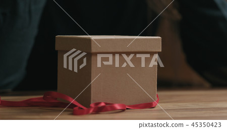 Closeup red ribbon and gift box 45350423