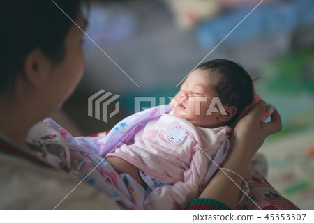 cute baby sleep on hand's mom 45353307