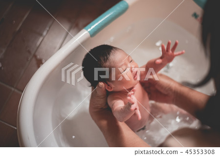baby taking a shower with her mom 45353308