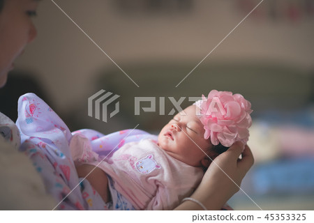 cute baby sleep on hand's mom 45353325