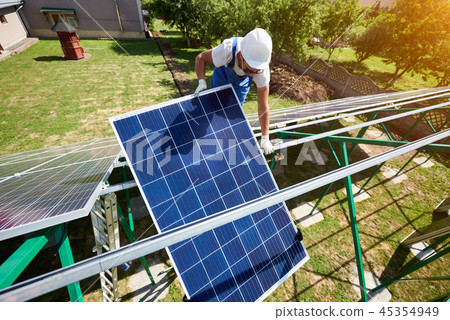 Mounting solar panels on green metallic carcass. Mounting solar panels on green metallic carcass. 45354949