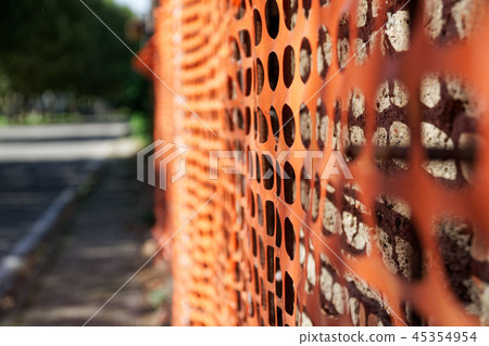 Construction safety fence, orange net around build Construction safety fence, orange net around build 45354954