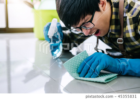 Husband housekeeping and cleaning concept, Happy young man in bl 45355831