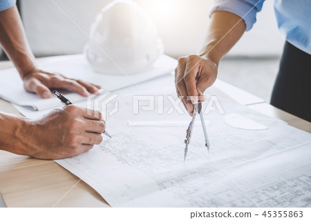 Hands of architect or engineer working on blueprint meeting for Hands of architect or engineer working on blueprint meeting for 45355863