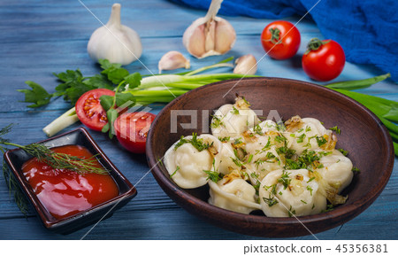 Dumplings in clay plate 45356381