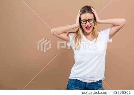 Young woman blocking her ears 45356801
