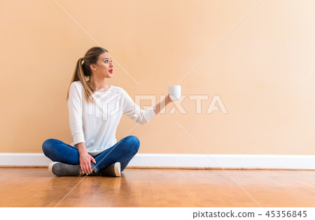 Young woman drinking a cup of coffee 45356845