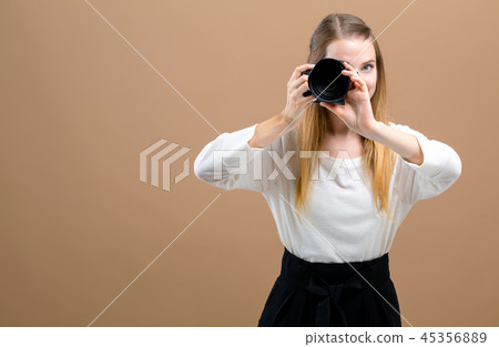 Young woman with a professional camera 45356889