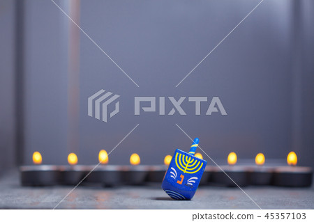 Defocused lights of Jewish holiday Hanukkah and spinning top Defocused lights of Jewish holiday Hanukkah and spinning top 45357103