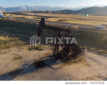 Oil derrick in the desert pumping WTI oil Oil derrick in the desert pumping WTI oil 45357638