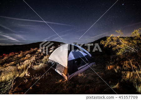 Camping in the tent in scenic desert against night 45357709