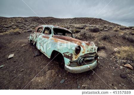 Old abandoned rusty car from 60`s in desert 45357889