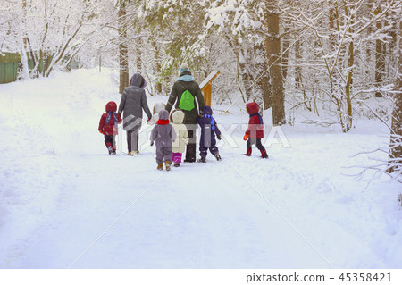 Group of unrecognizable litle kids with teachers of kindergarten, back to us, walk holding hands in Group of unrecognizable litle kids with teachers of kindergarten, back to us, walk holding hands in 45358421