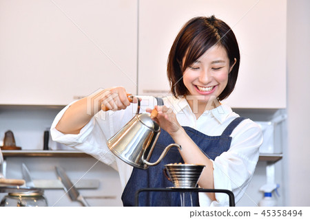 A woman in a cafe serving drip coffee 45358494