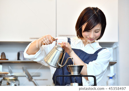 A woman in a cafe serving drip coffee 45358497