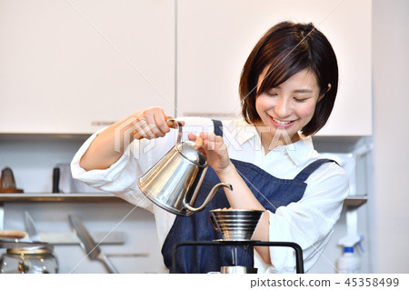 A woman in a cafe serving drip coffee 45358499