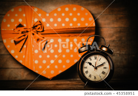 alarm clock on the table with heart shape gift alarm clock on the table with heart shape gift 45358951