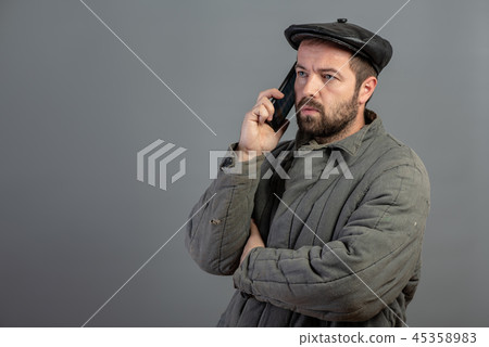 Serious man 35 years old speaks on mobile phone 45358983