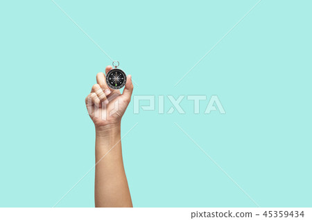 Hand holding compass 45359434