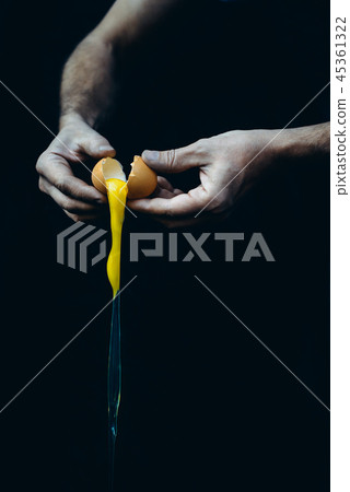 Man broking egg for baking 45361322