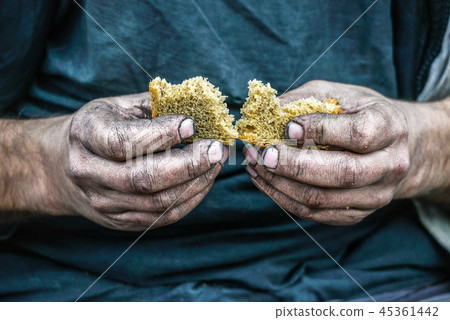 Dirty hands homeless poor man with piece of bread  45361442