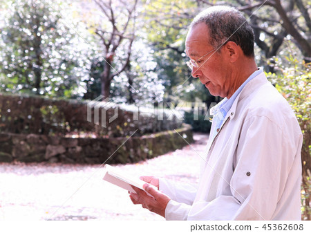 Senior reading a book outdoors Senior reading a book outdoors 45362608