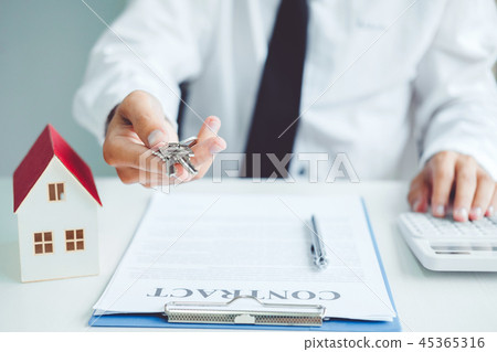 Sale agent giving house to customer and sign Sale agent giving house to customer and sign 45365316
