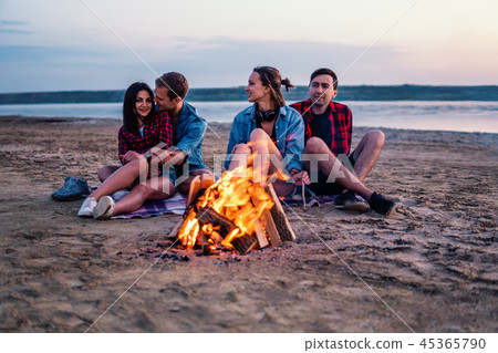 young friends have picnic with bonfire on the beach young friends have picnic with bonfire on the beach 45365790
