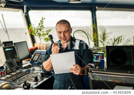 Marine navigational officer is reporting by VHF radio Marine navigational officer is reporting by VHF radio 45365809