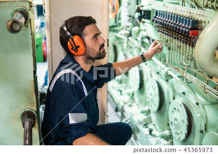 Marine engineer officer working in engine room Marine engineer officer working in engine room 45365973
