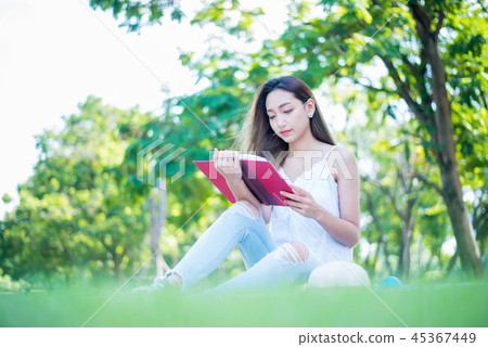 Young woman relaxing in the natural park.  45367449