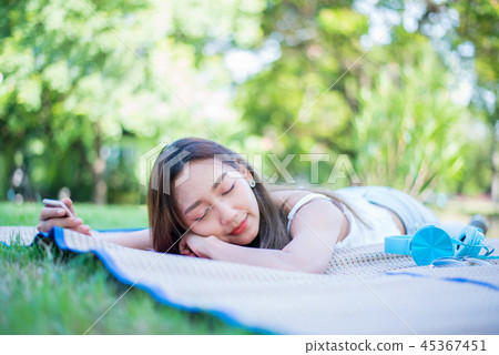 Young woman relaxing in the natural park.  45367451