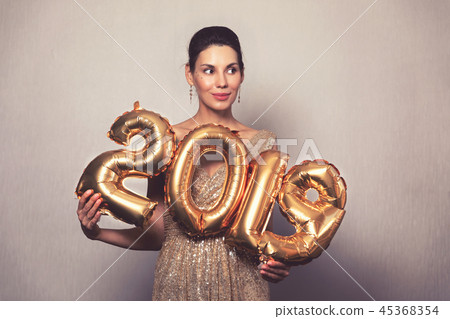 Happy New Year. Beautiful Woman with Balloons Celebrating new year's Eve Party. Smiling Girl in Happy New Year. Beautiful Woman with Balloons Celebrating new year's Eve Party. Smiling Girl in 45368354