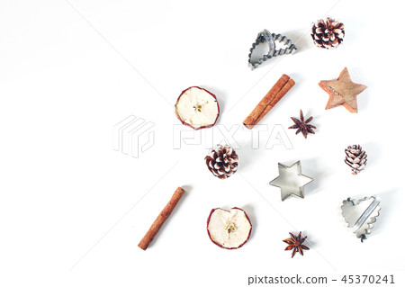 Christmas festive styled food composition, pattern. Pine cones, dried apple fruit, cinnamon, vintage Christmas festive styled food composition, pattern. Pine cones, dried apple fruit, cinnamon, vintage 45370241