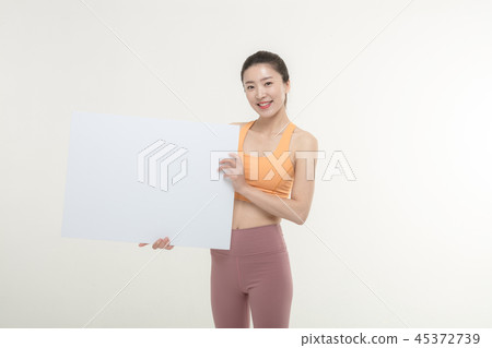 a woman holding an ad board on a white background a woman holding an ad board on a white background 45372739