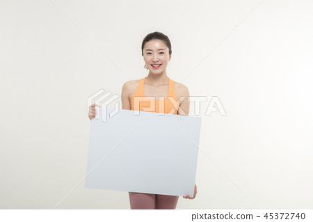 a woman holding an ad board on a white background a woman holding an ad board on a white background 45372740