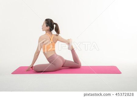 A Korean woman doing yoga exercise on mat A Korean woman doing yoga exercise on mat 45372828