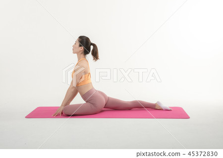 A Korean woman doing yoga exercise on mat A Korean woman doing yoga exercise on mat 45372830