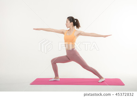 A Korean woman doing yoga exercise on mat A Korean woman doing yoga exercise on mat 45372832
