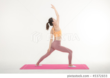 A Korean woman doing yoga exercise on mat A Korean woman doing yoga exercise on mat 45372833