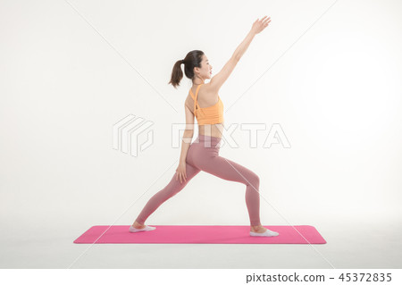 A Korean woman doing yoga exercise on mat A Korean woman doing yoga exercise on mat 45372835