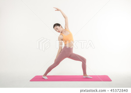 A Korean woman doing yoga exercise on mat A Korean woman doing yoga exercise on mat 45372840