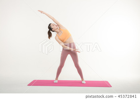 A Korean woman doing yoga exercise on mat A Korean woman doing yoga exercise on mat 45372841