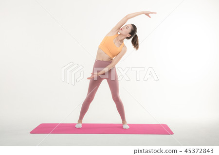 A Korean woman doing yoga exercise on mat 45372843