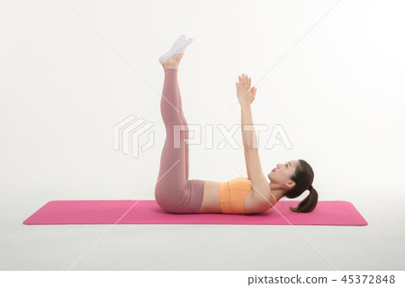 A Korean woman doing yoga exercise on mat A Korean woman doing yoga exercise on mat 45372848