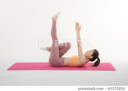 A Korean woman doing yoga exercise on mat A Korean woman doing yoga exercise on mat 45372850